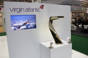 AIRCRAFT INTERIORS - Virgin Atlantic stool on display with complimentary video play